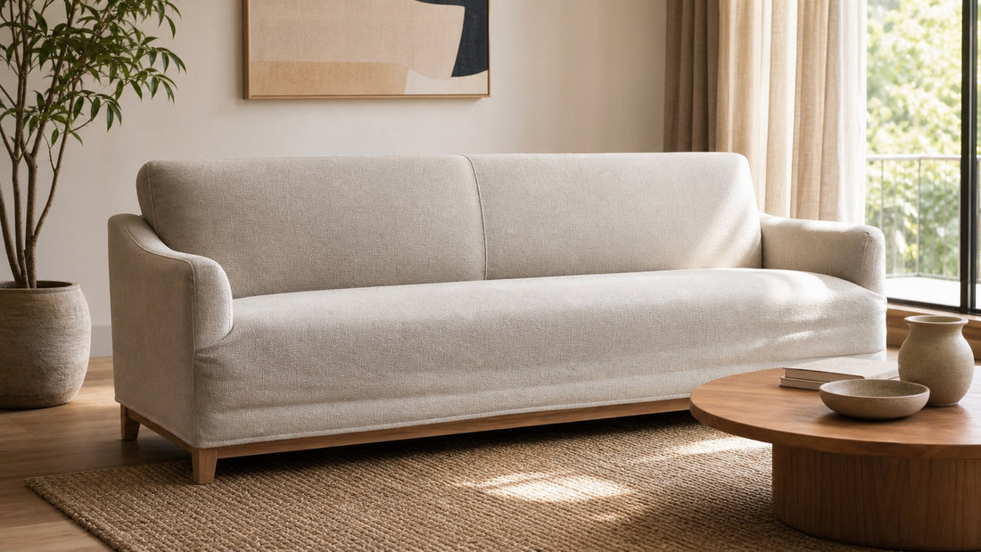 Sofa with attached back cushions and a fixed bench seat fitted with a neutral cover
