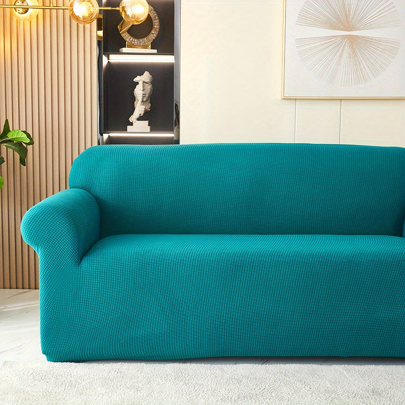 Calma cover in the option labelled Olive Green, shown in blue-green; closer view of the seat, arm and back