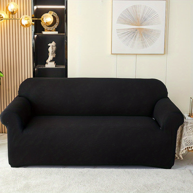 Calma sofa cover in Black, front view of the fitted sofa cover