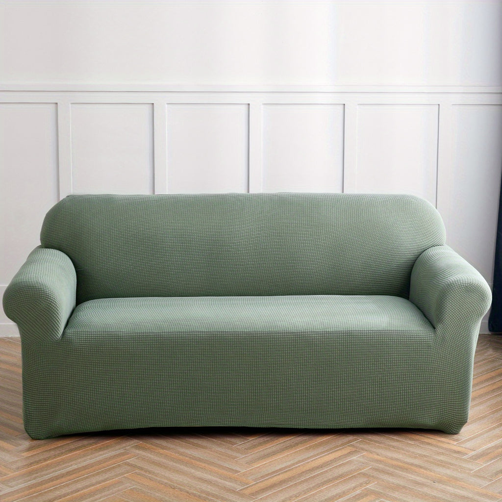 Calma sofa cover in Blackish Green, front view of the fitted sofa cover