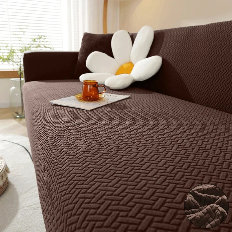 Brown Verona Geometric cover across a sofa seat, backrest and arm, with raised interlocking texture