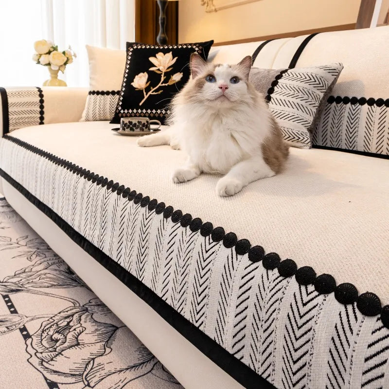 Cat on a beige Marlow sofa panel with patterned border and round black trim.