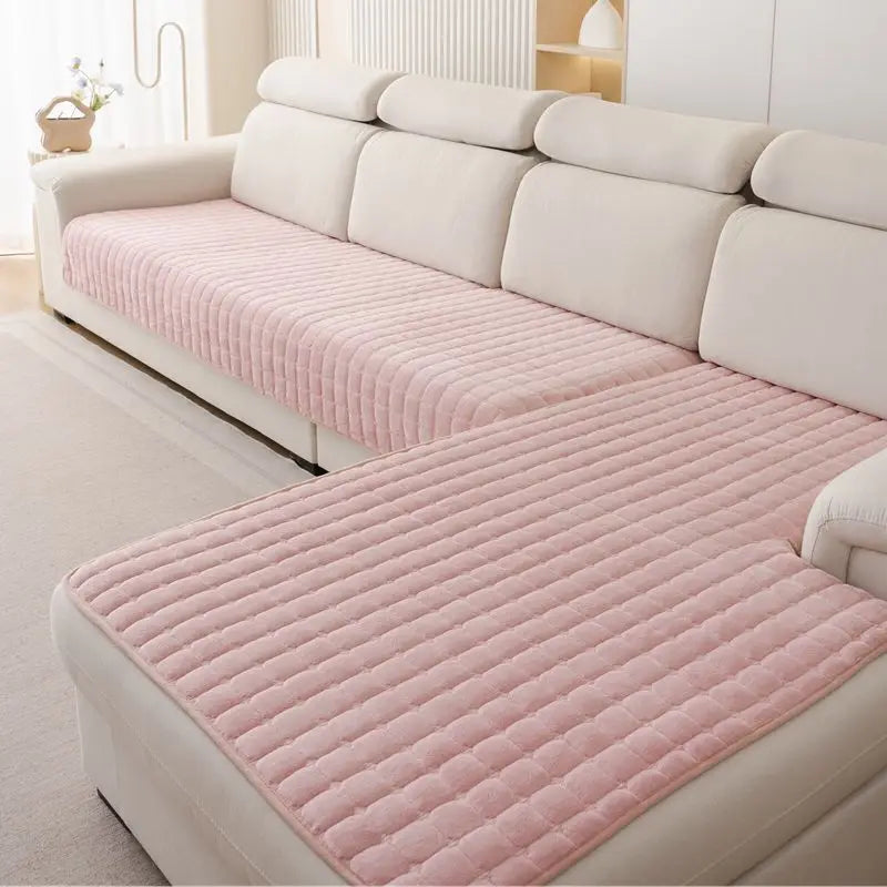 Pink Velluto cover pieces draped over the seat and chaise of a cream sofa