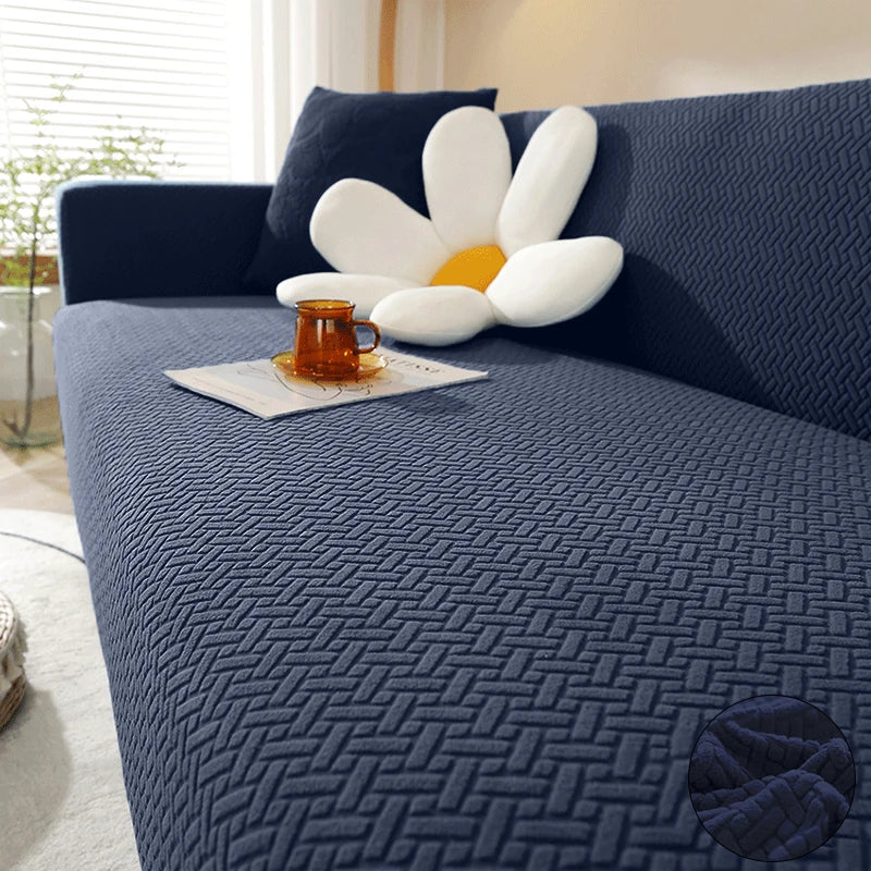 Navy blue Verona Geometric cover across a sofa seat, backrest and arm, with raised interlocking texture