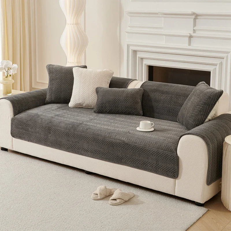 Umbria dark grey chevron-pattern cover pieces arranged on a sofa
