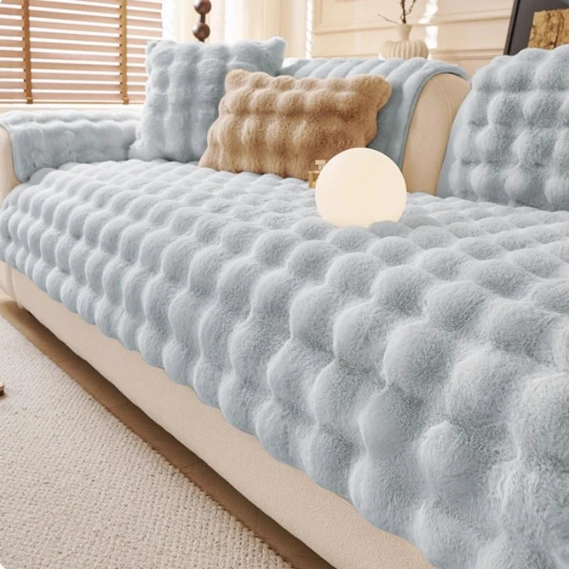 Light grey Aurelia faux fur cover pieces and cushions on a sofa
