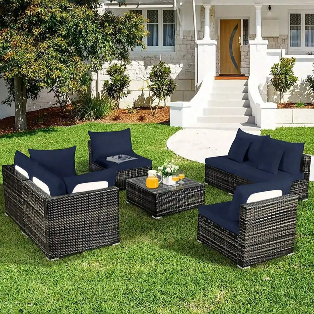 Tropical outdoor sofa cushion covers in dark blue on grey rattan patio furniture set with matching throw pillows