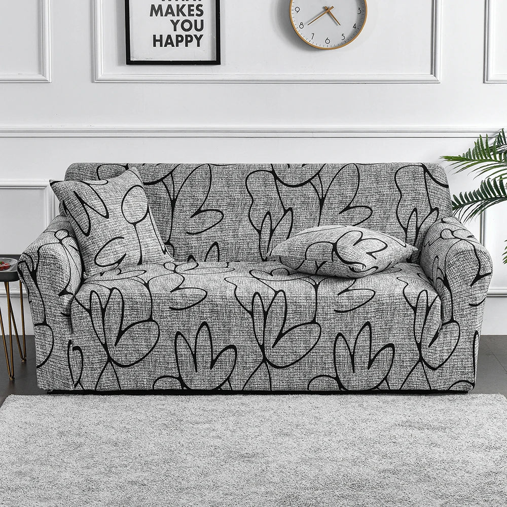 Sofa fitted with Celeste Color 01 cover showing black outlined leaf shapes on grey