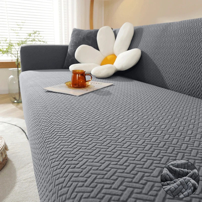 Dark grey Verona Geometric cover across a sofa seat, backrest and arm, with raised interlocking texture