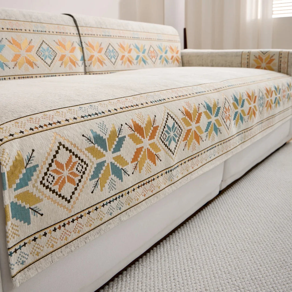 Beige Sorrento cover pieces on a white sofa, showing a geometric border along the front edge