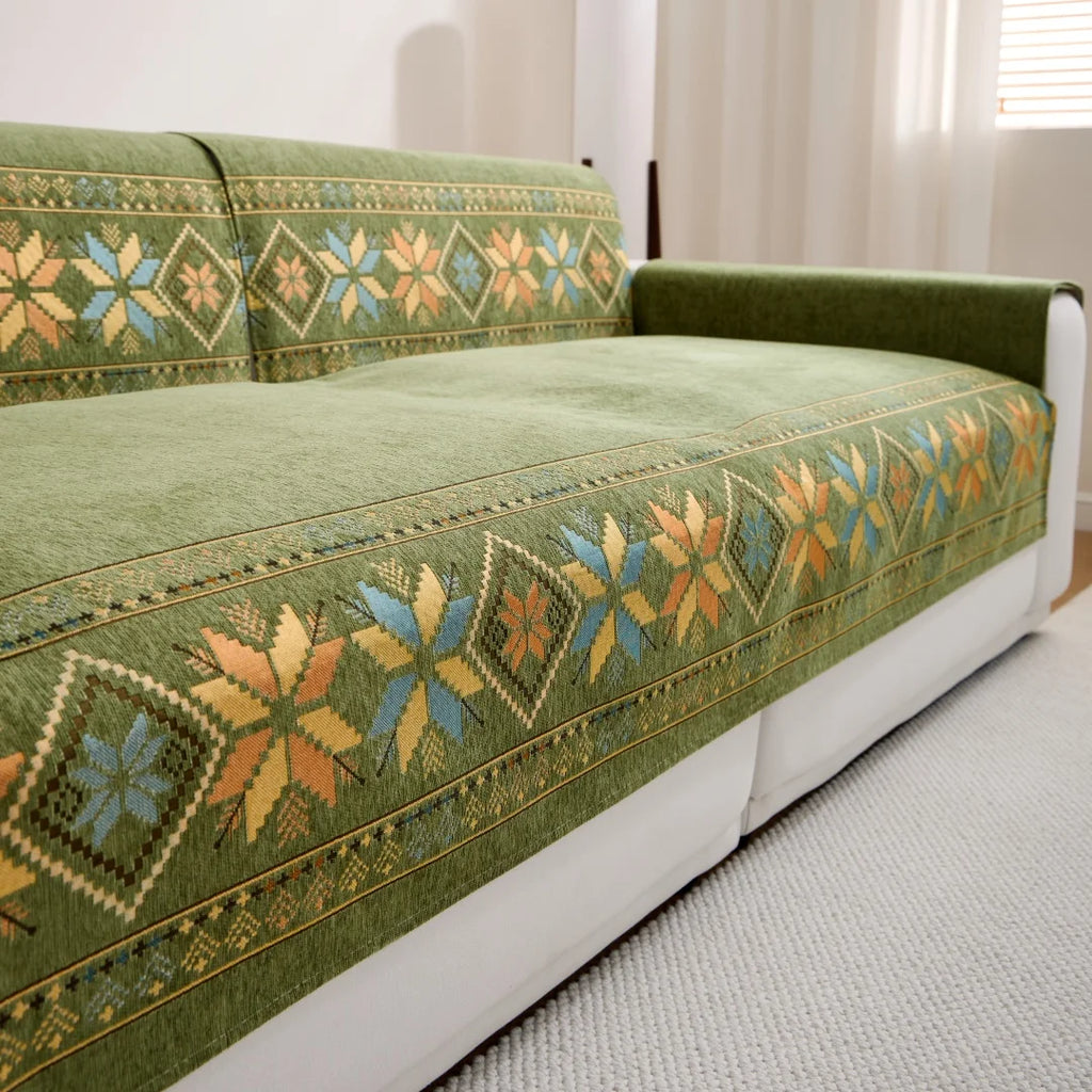 Green Sorrento cover pieces with geometric borders across the sofa seat and backrests