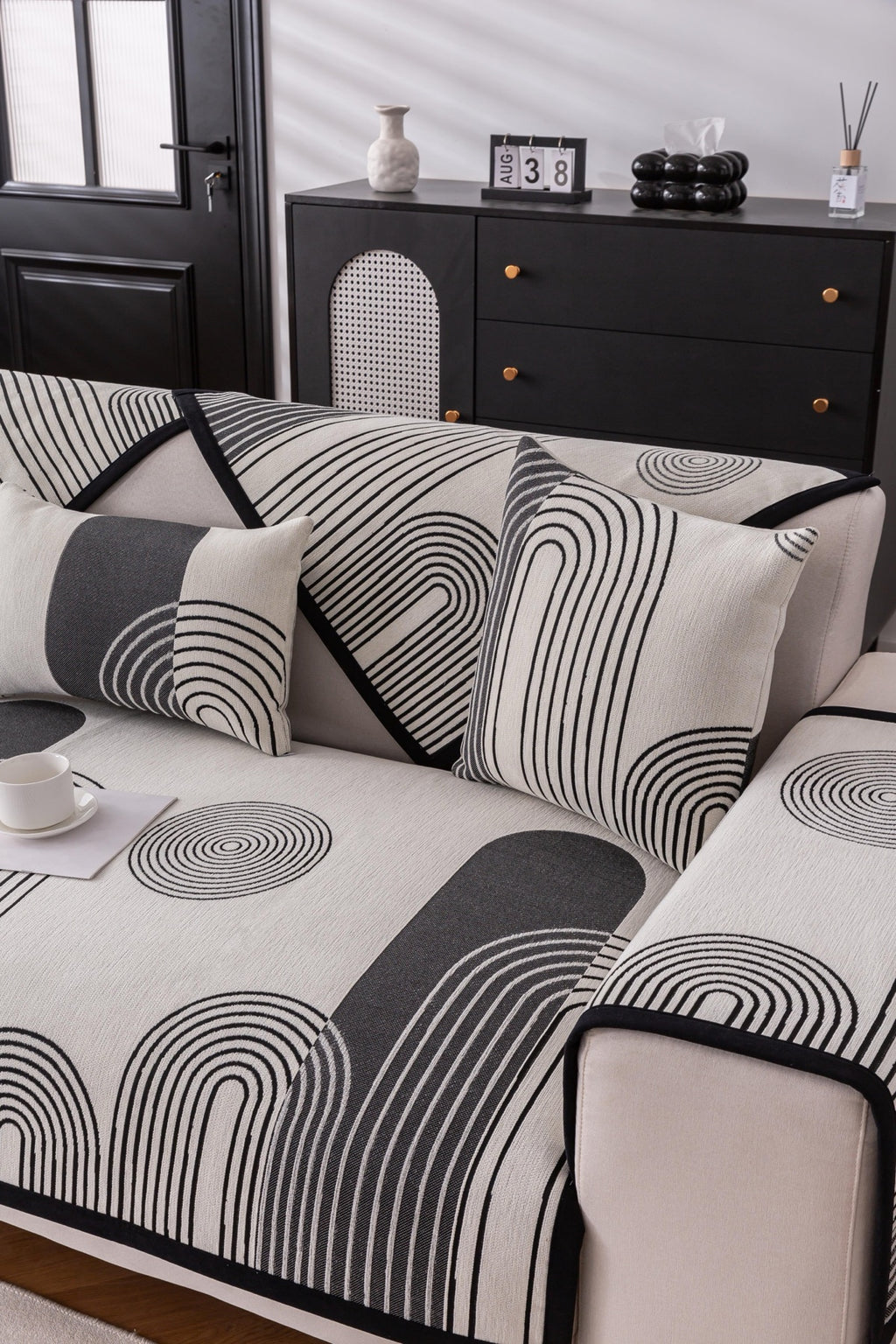 Sofa Decor Arcadia Arch Line Sofa Cover in Black Cream - styled sofa image for water resistant patterned couch covers in Australia
