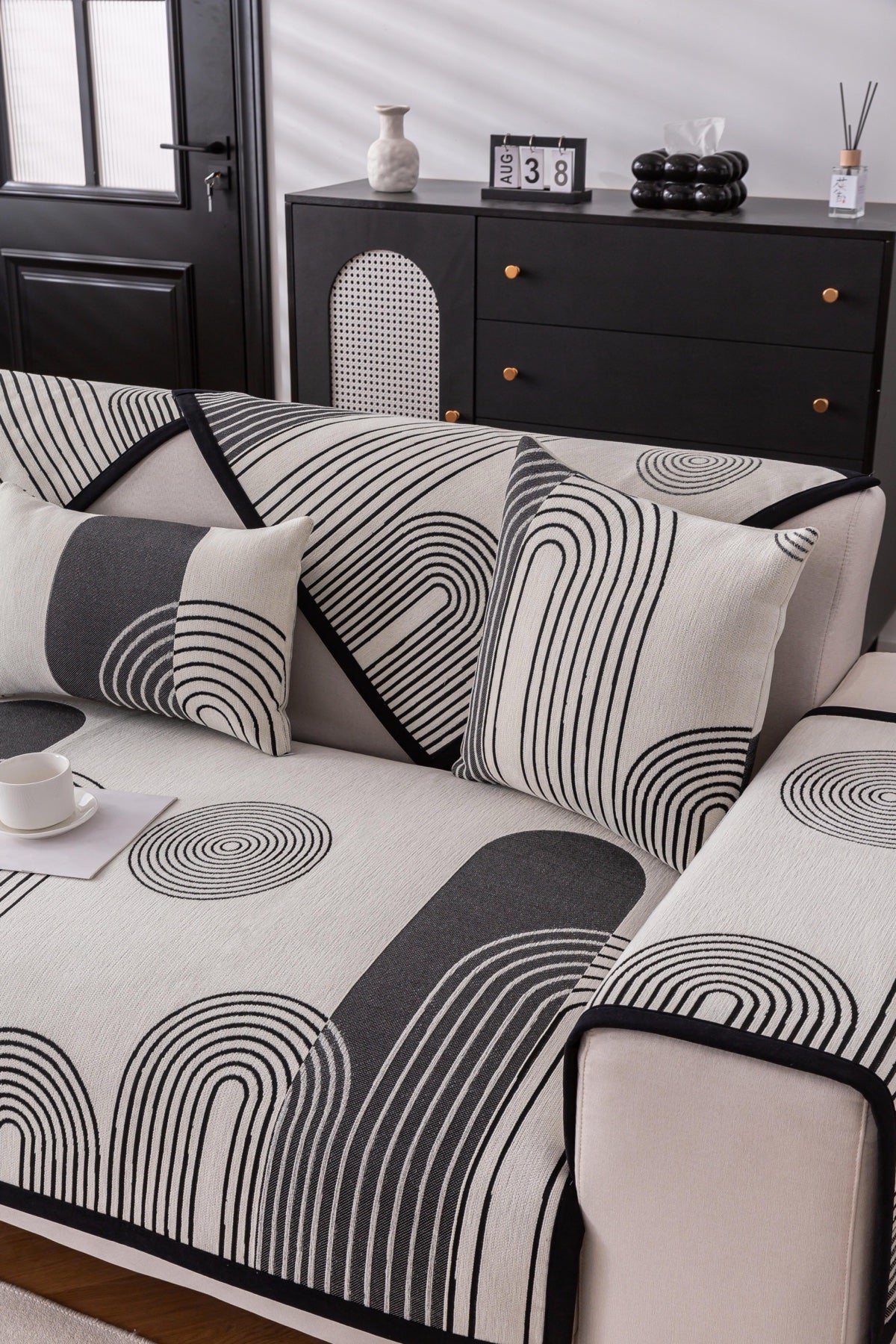 Sofa Decor Arcadia Arch Line Sofa Cover in Black Cream - styled sofa image for water resistant patterned couch covers in Australia