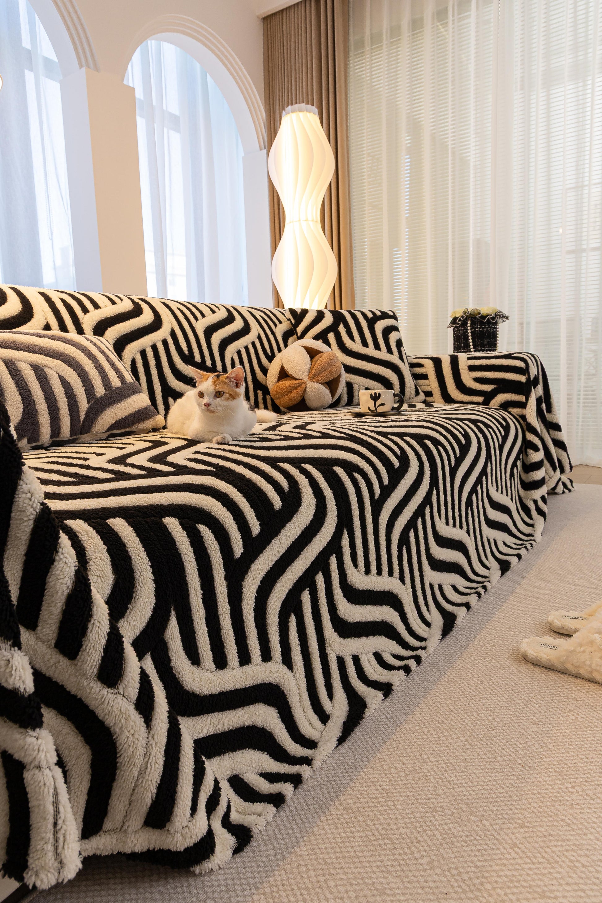 Sofa Decor Riviera Wave Stripe Sofa Cover in Black Cream - styled sofa image for plush patterned couch covers in Australia
