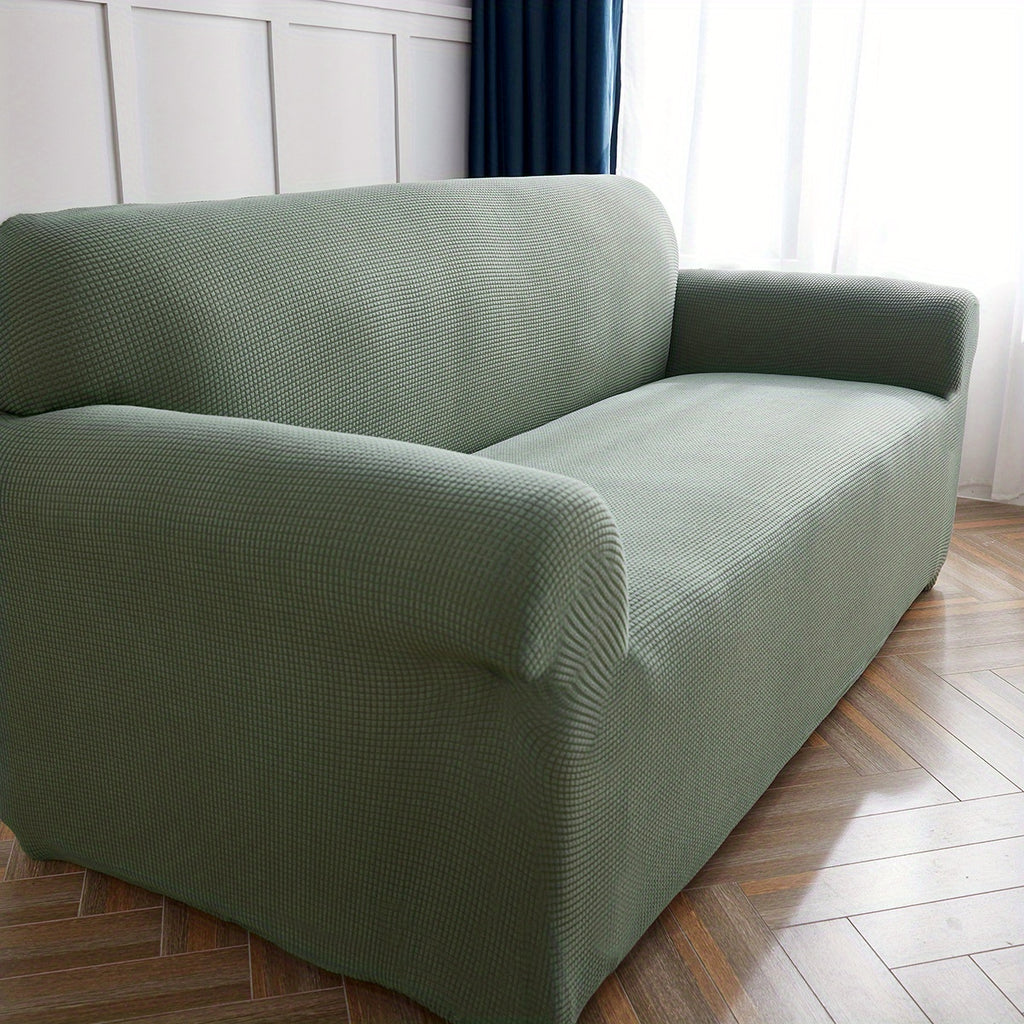 Calma sofa cover in Blackish Green, closer view of the seat, arm and back
