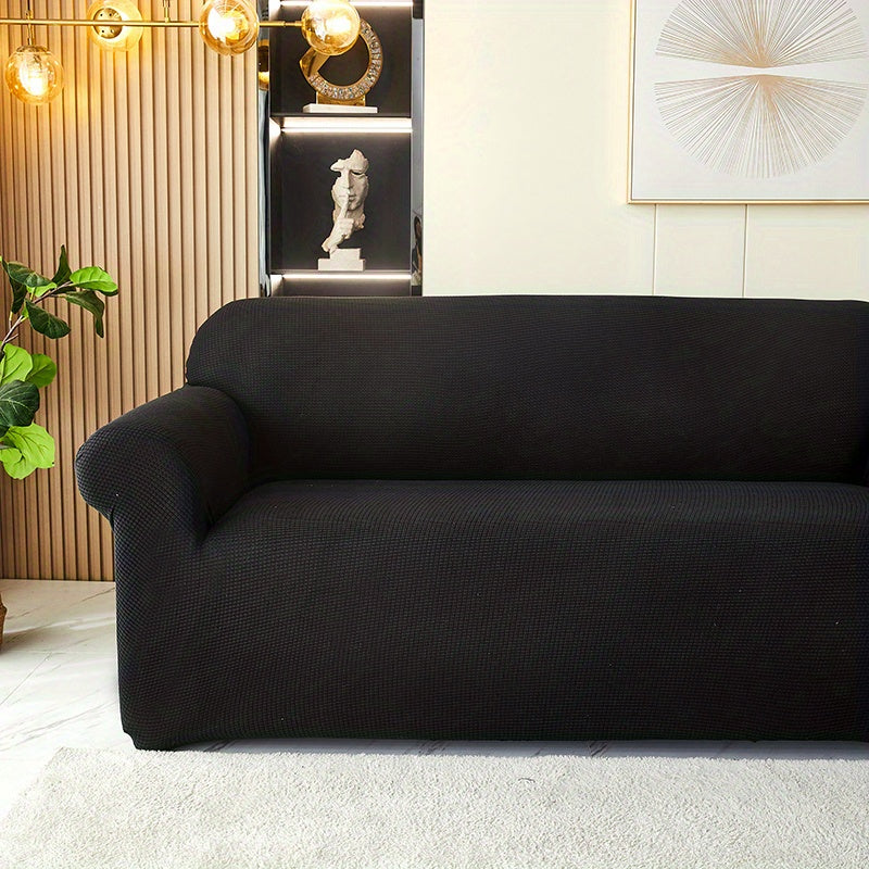 Calma sofa cover in Black, closer view of the seat, arm and back