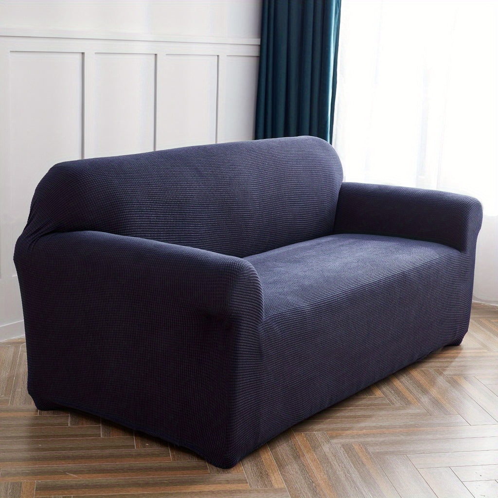 Calma sofa cover in navy blue, angled view of the fitted shape