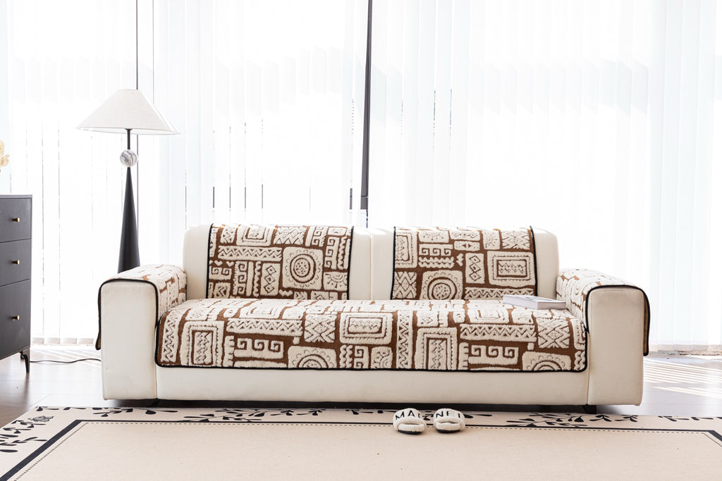 Front view of brown and ivory Elara cover pieces on a cream sofa.
