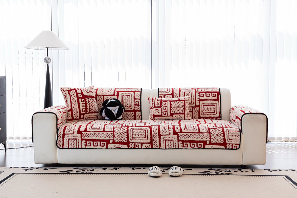 Front view of Elara red and ivory geometric covers with patterned cushions.