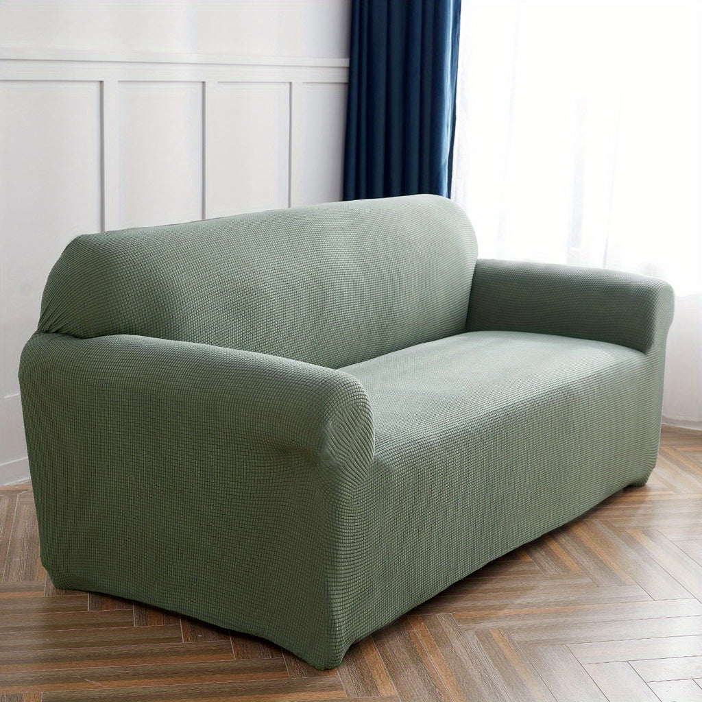 Calma sofa cover in Blackish Green, angled view of the fitted shape