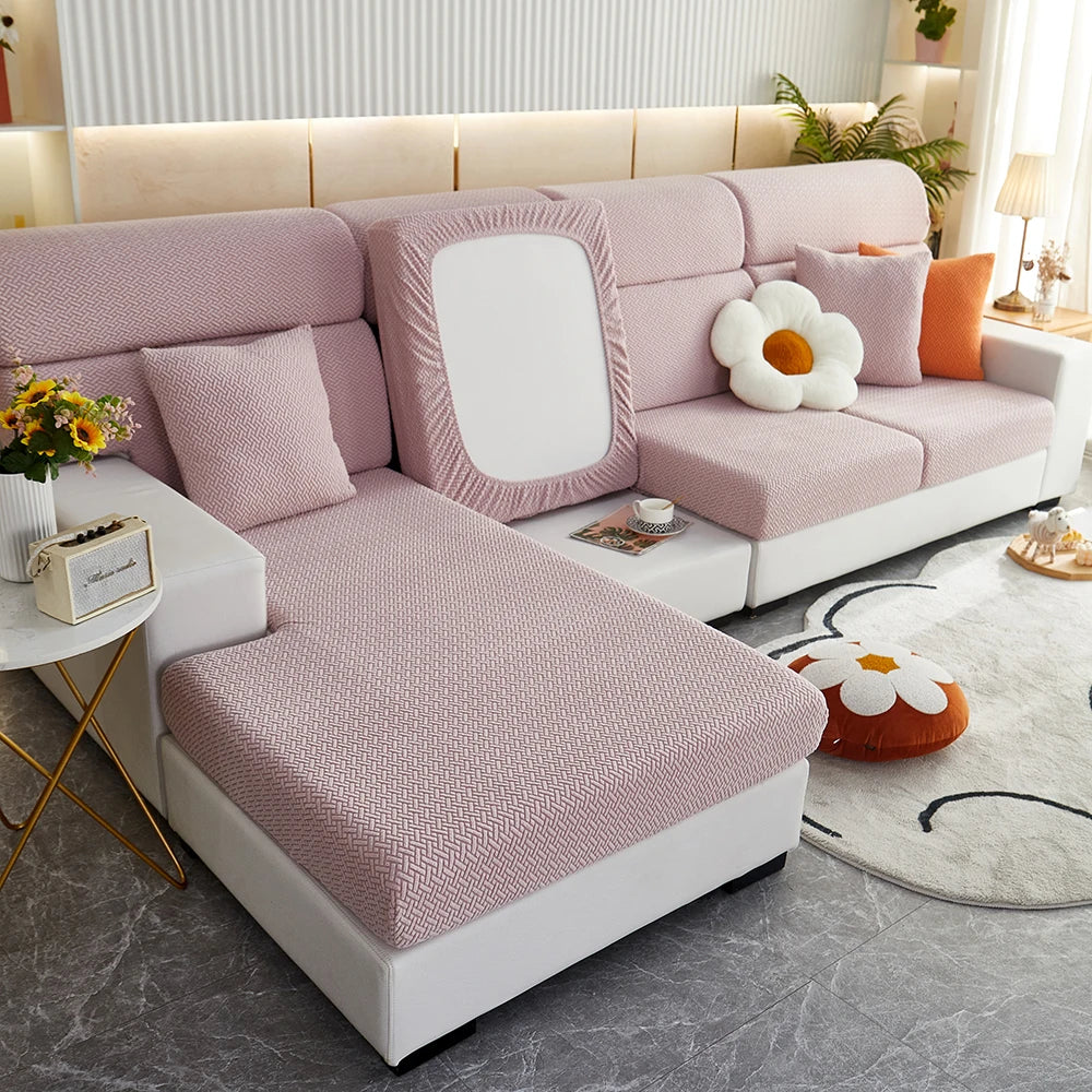 Jacquard twill sofa slipcover in pink on L-shaped modern living room sofa with decorative cushions