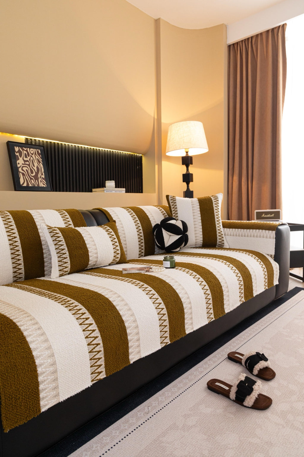 Golden-brown and cream Marlow striped pieces arranged across a sofa