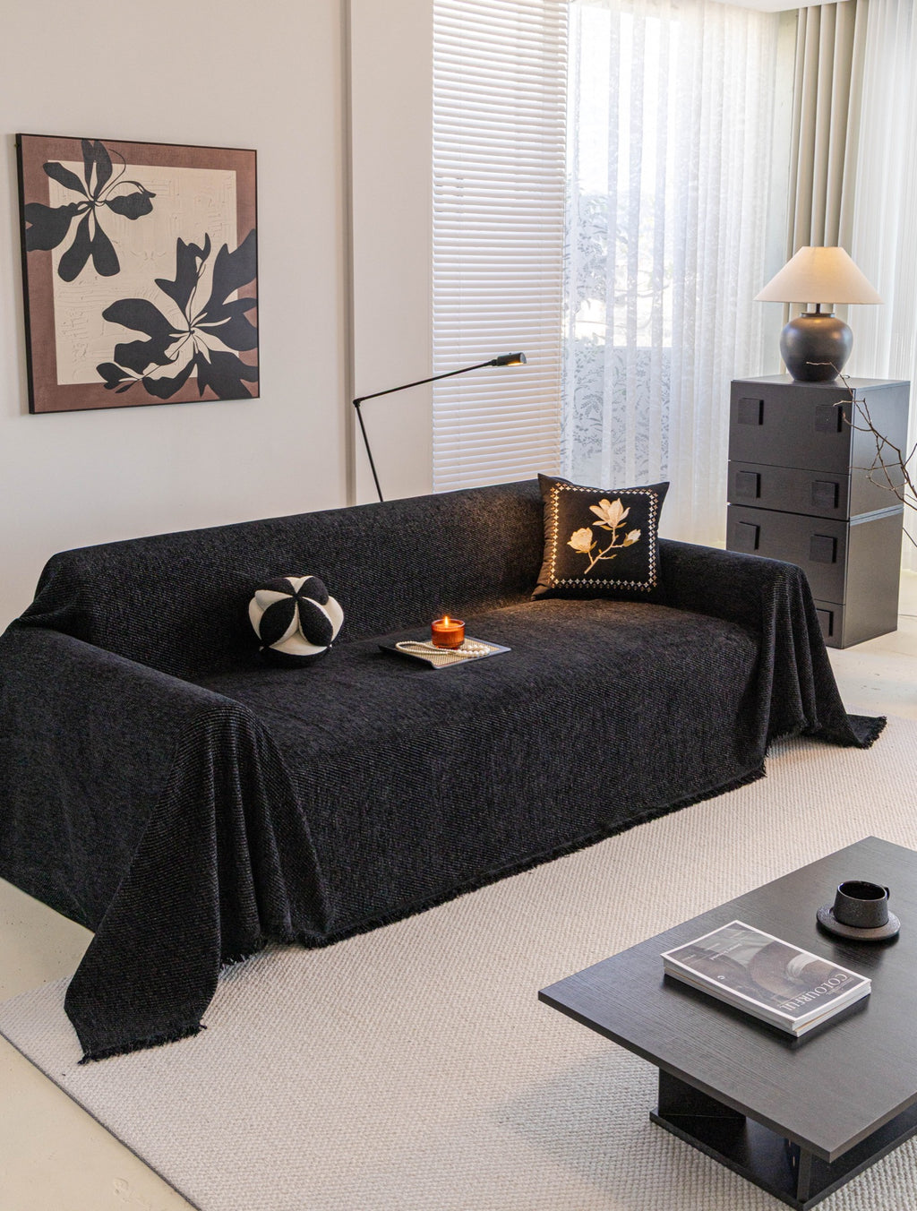 Charcoal-black Milano ribbed throw draped over a sofa with fringe at the front and sides