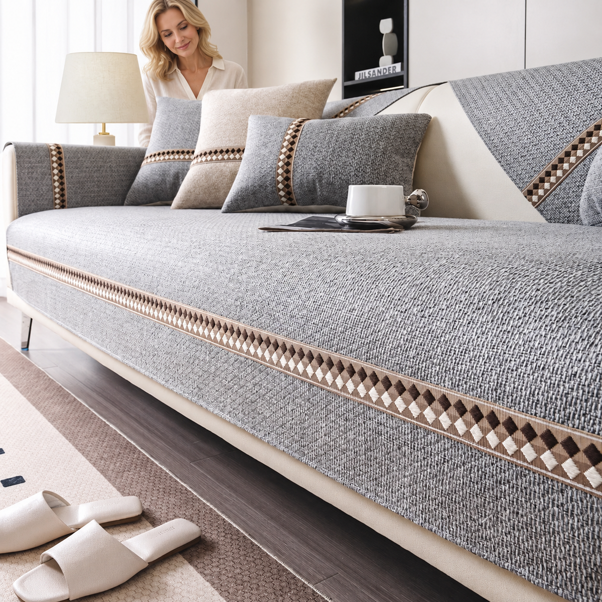 Sofa Decor Haven Thick All Season Sofa Cover in A4 Grey, styled with a blonde woman.