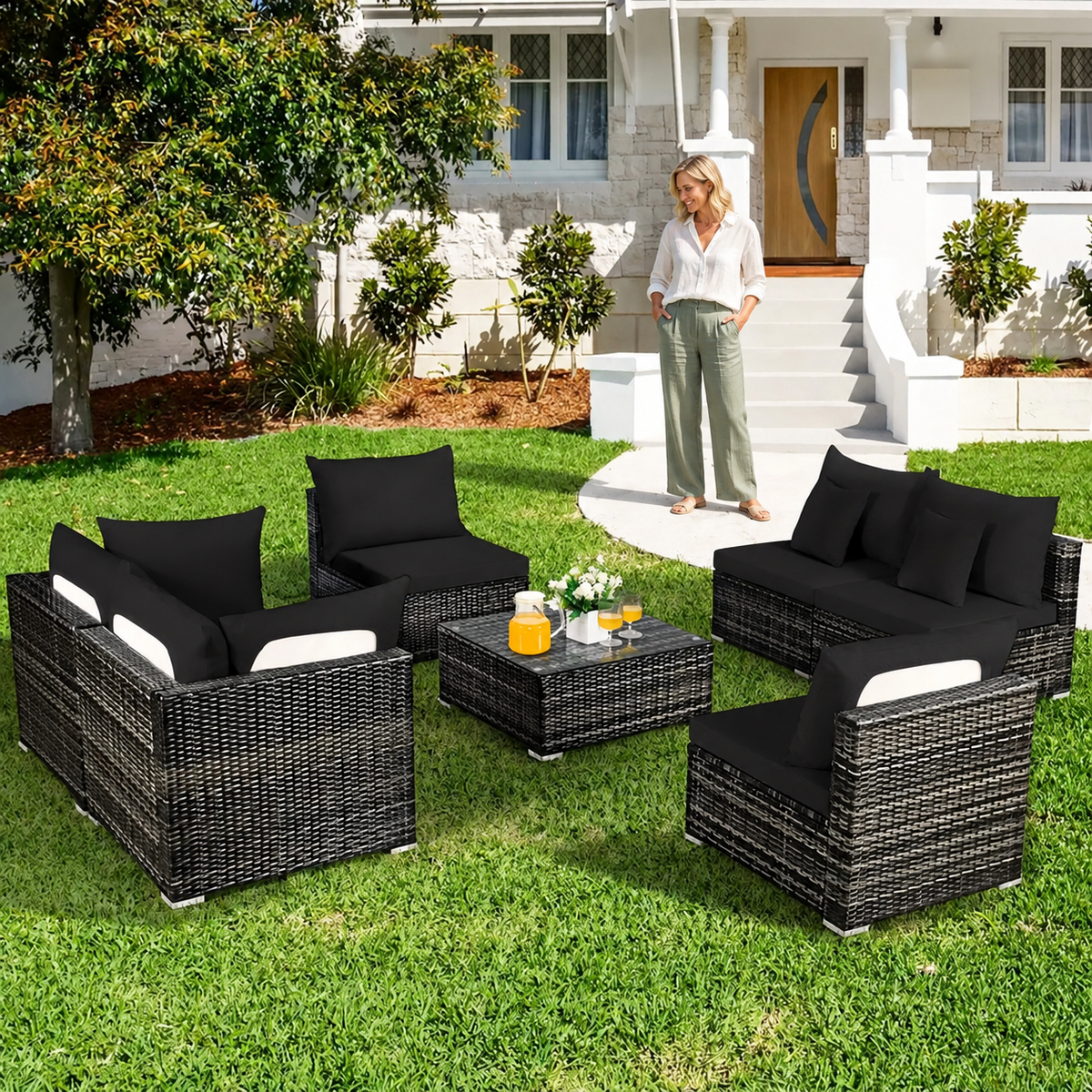 Sofa Decor Palm Cove Tropical Outdoor Cushion Covers in black, styled with a blonde woman.