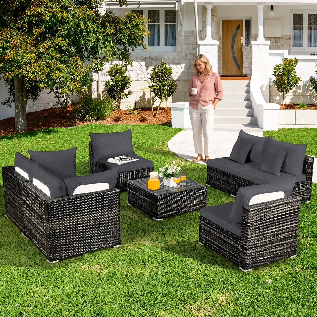 Sofa Decor Palm Cove Tropical Outdoor Cushion Covers in dark grey, styled with a blonde woman.