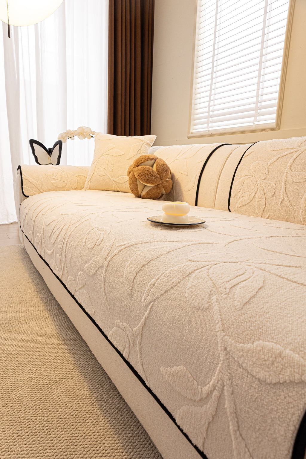 Willow Ivory Leaf cream leaf-pattern covers arranged on a sofa